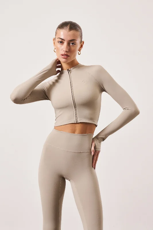 SCULPTING EMBLEM ZIP THROUGH TOP - BEIGE