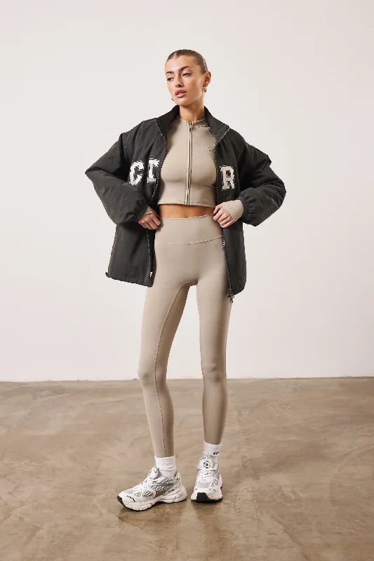 SCULPTING EMBLEM ZIP THROUGH TOP - BEIGE